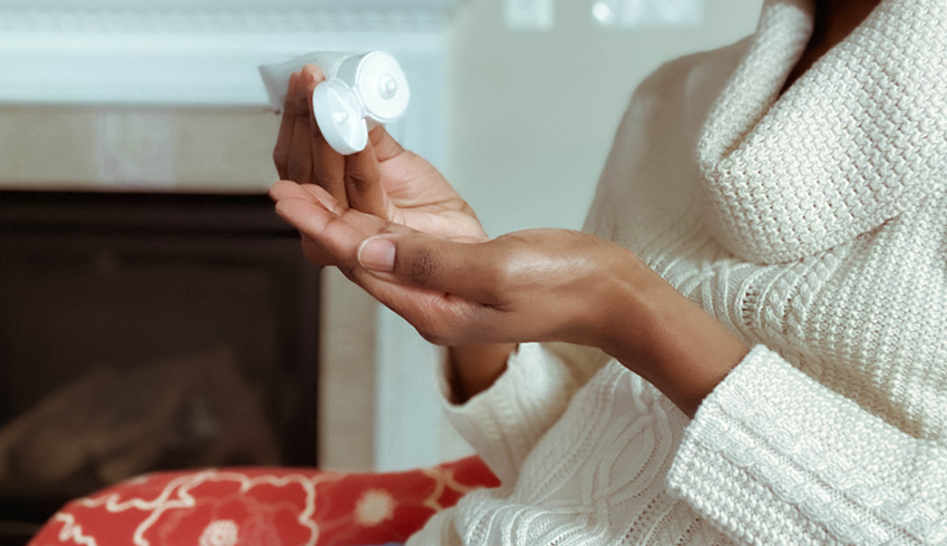 woman applying moisturizer